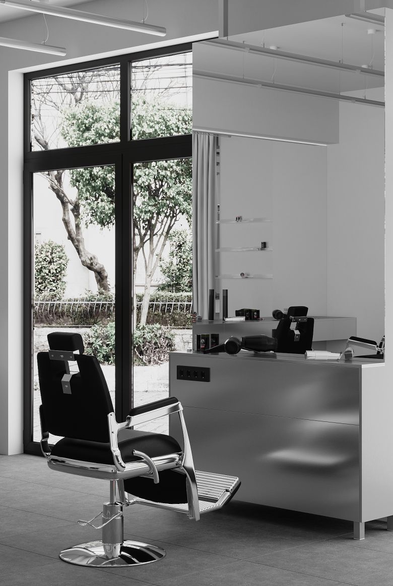 A black and white photo of a barber chair designed by 10:02 Bureau for Manufaktura Barbera in Krakow